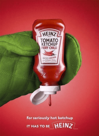 heinz ad that shows someone holding the ketchup bottle with an oven mitt